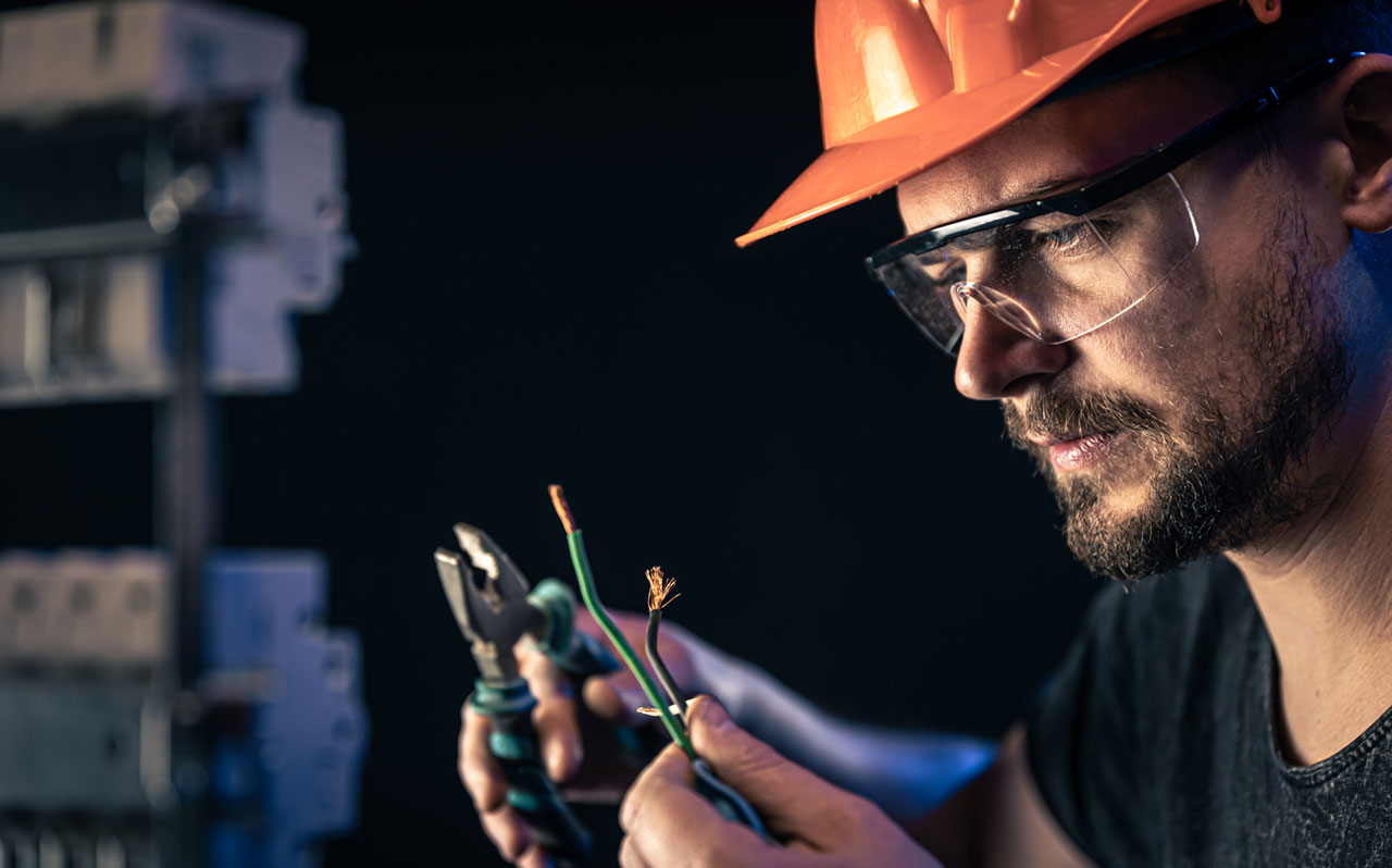 Electrician working on a switchboard in Minneapolis, MN